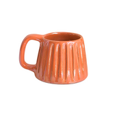 Handcrafted ceramic mug with an iridescent orange glaze, radiating citrusy warmth and playful energy. Its smooth shape and easy-grip handle make it a vibrant choice for your daily rituals.