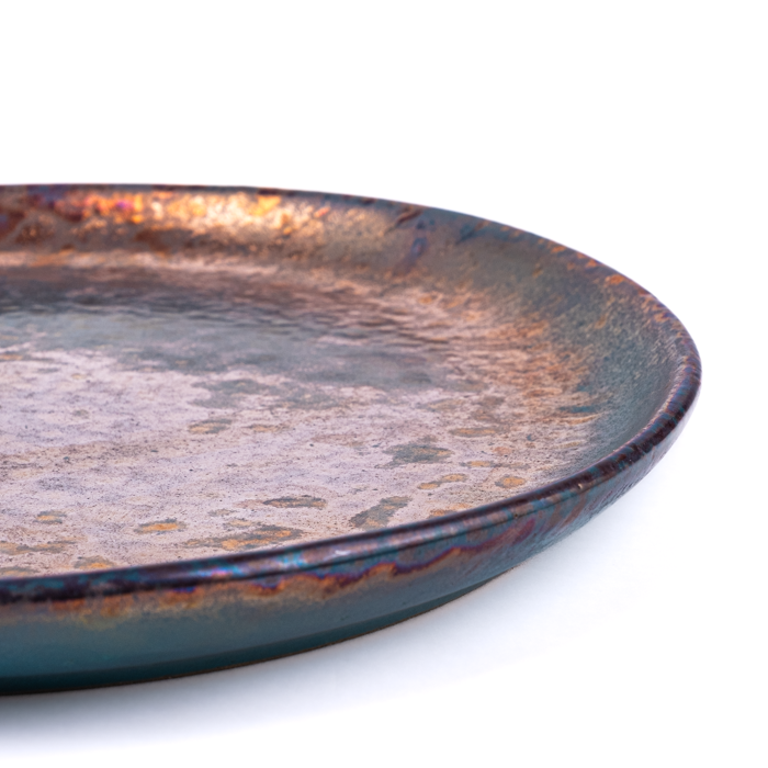 Medium handcrafted stoneware plate with textured surface and artisanal design
