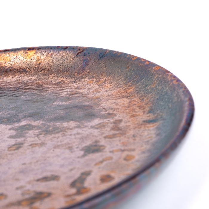 Medium handcrafted stoneware plate with textured surface and artisanal design