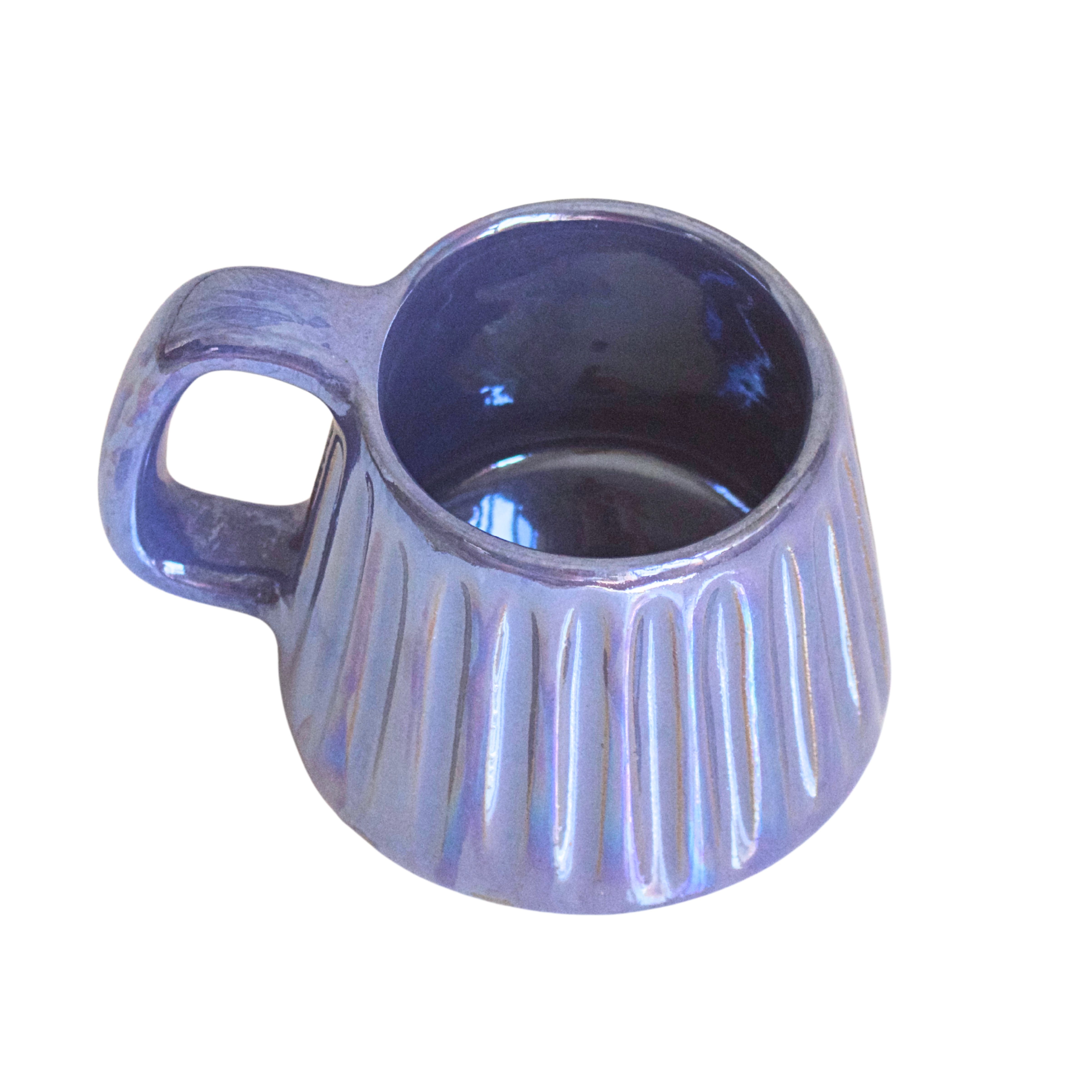 Handcrafted ceramic mug with an iridescent glaze in layered sea tones of blue and green, echoing ocean waves. Its organic shape and curved handle bring a calming, coastal vibe to every sip.

