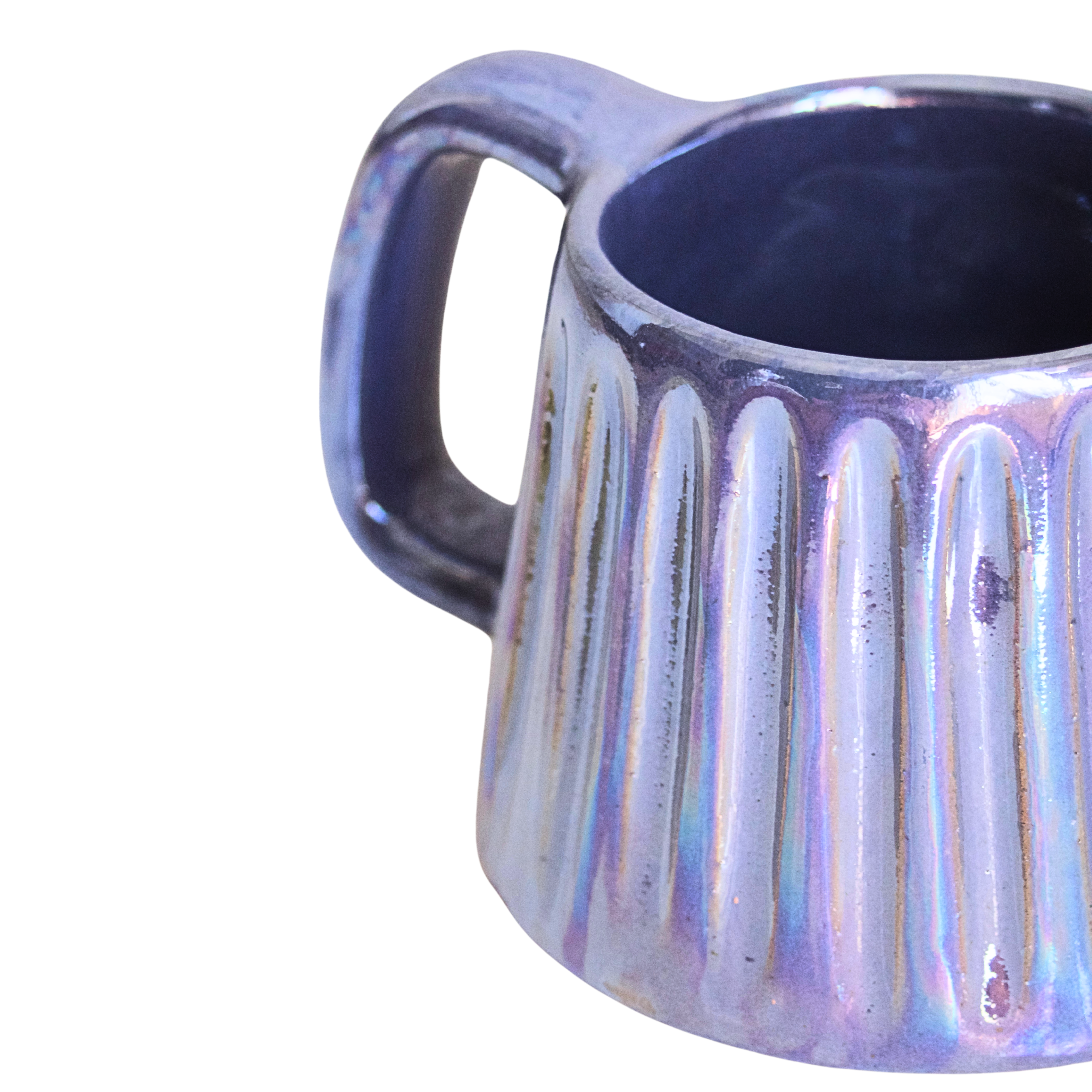 Handcrafted ceramic mug with an iridescent glaze in layered sea tones of blue and green, echoing ocean waves. Its organic shape and curved handle bring a calming, coastal vibe to every sip.

