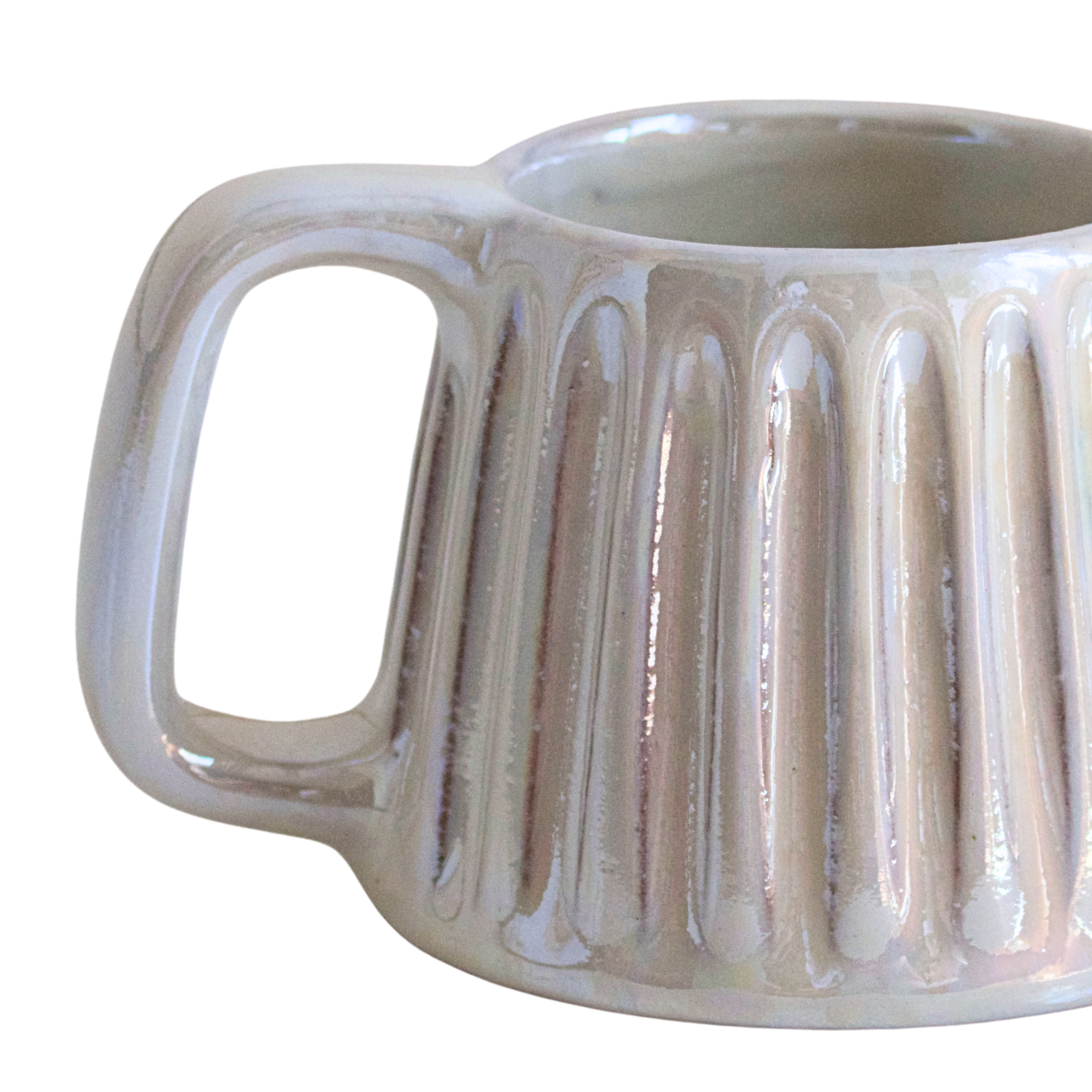 Handcrafted ceramic mug in a soft pearlescent white glaze, featuring a smooth, rounded shape and a minimalist handle. Perfect for elevating everyday rituals with a touch of elegance and simplicity.

