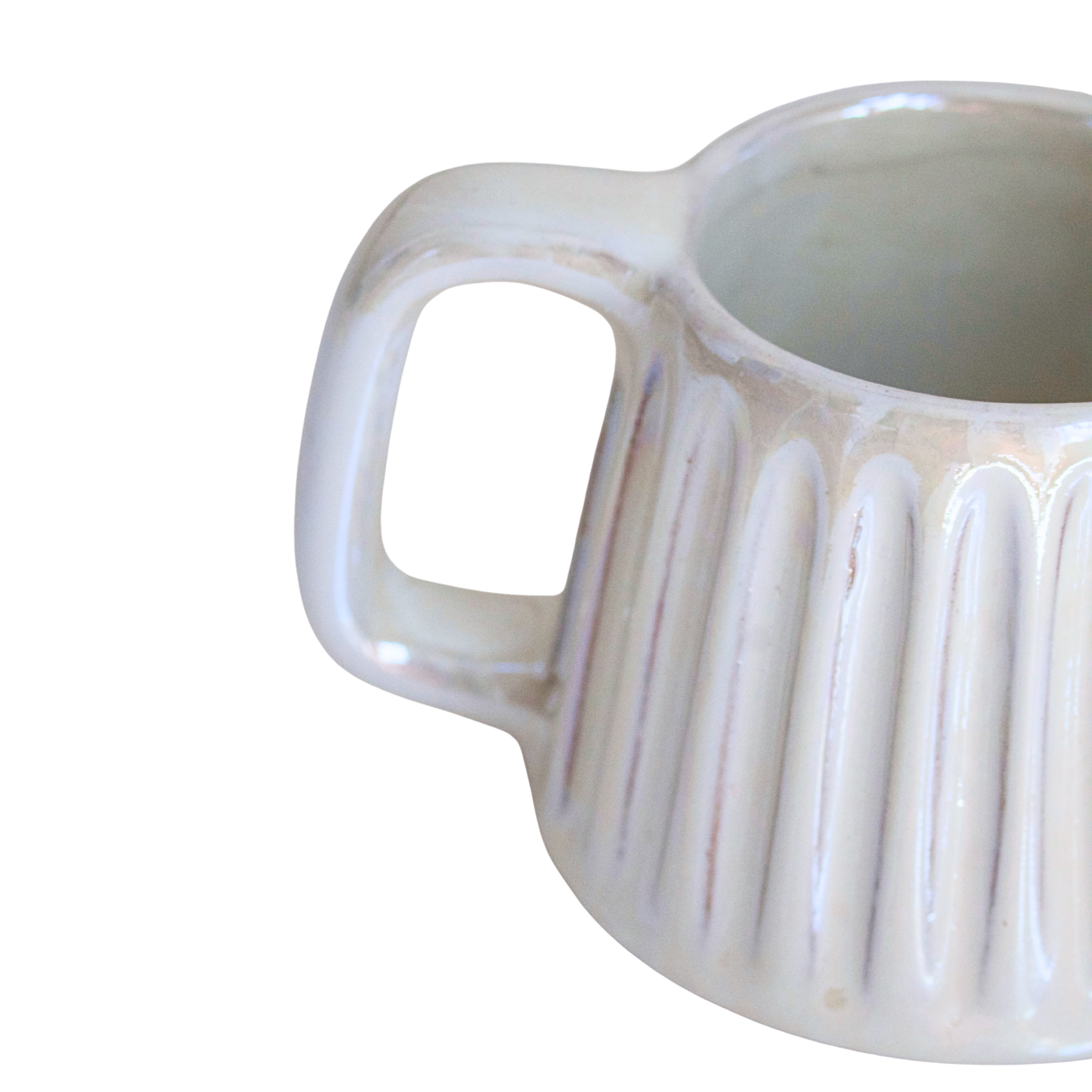 Handcrafted ceramic mug in a soft pearlescent white glaze, featuring a smooth, rounded shape and a minimalist handle. Perfect for elevating everyday rituals with a touch of elegance and simplicity.

