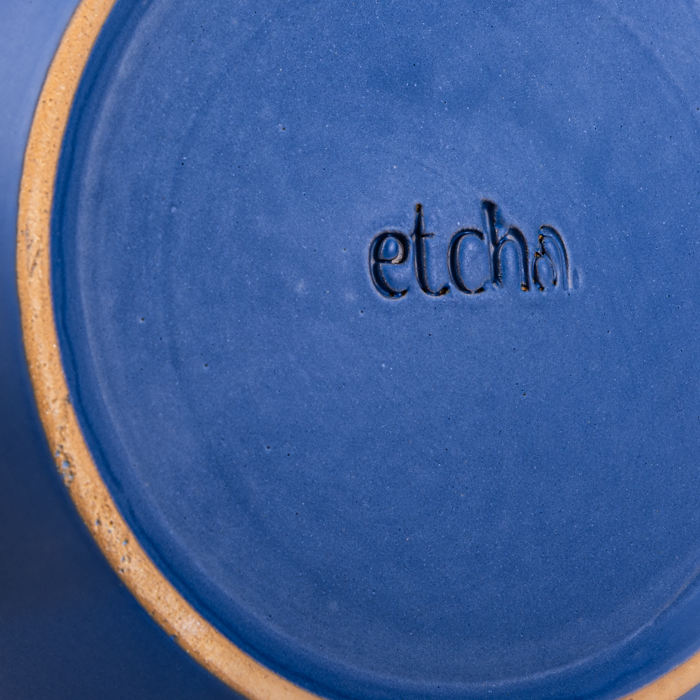 Large handcrafted stoneware serving bowl with textured surface and artisanal design